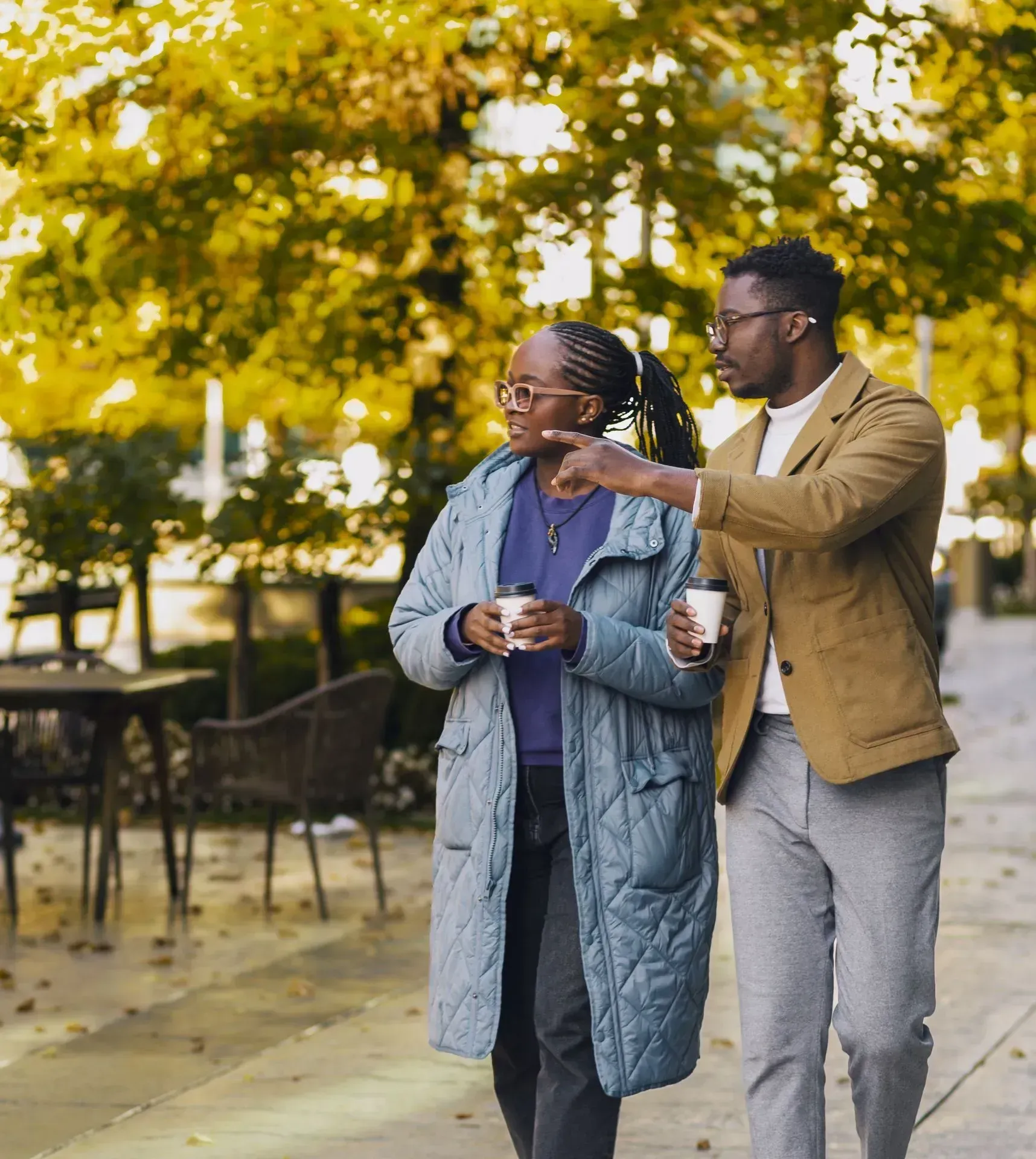 Two residents walking outdoors near Waterline Apartment Residences
